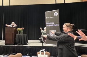 Group of people doing making a "roaring" gesture.