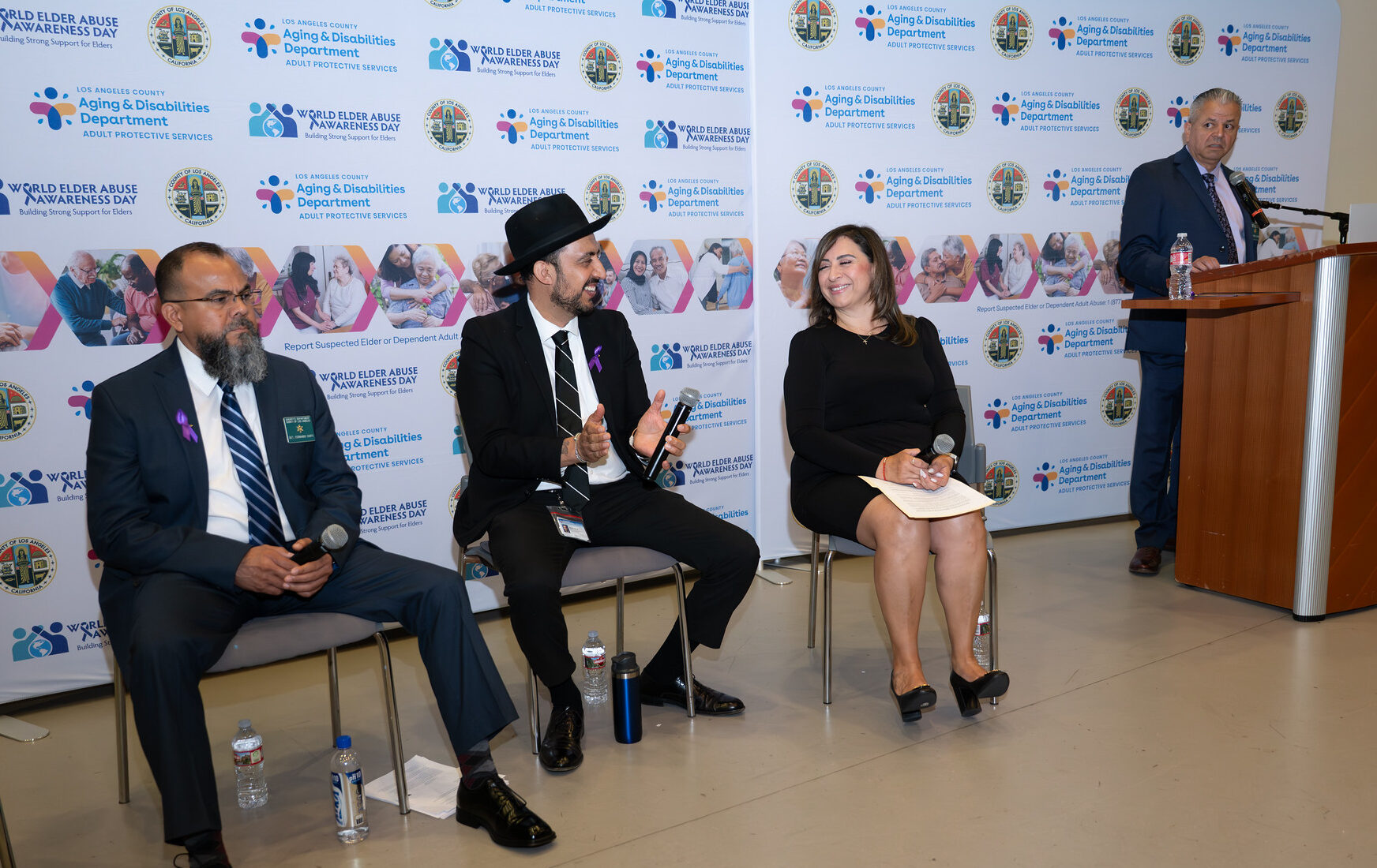 A group of people sit at a panel.